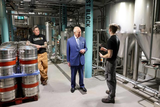 Britain's King Charles III is given a tour of the microbrewery by Master Brewer Hollie Stephenson (L) during his visit to officially open the Guinness Open Gate Brewery London on December 18, 2025. The Guinness Open Gate Brewery, a Ј73 million investment, contains a microbrewery, visitor experience, restaurants, shops, and events space, and will serve as the UK southern hub for Diageo’s award-winning Learning for Life programme. (Photo by Chris Jackson / POOL / AFP)