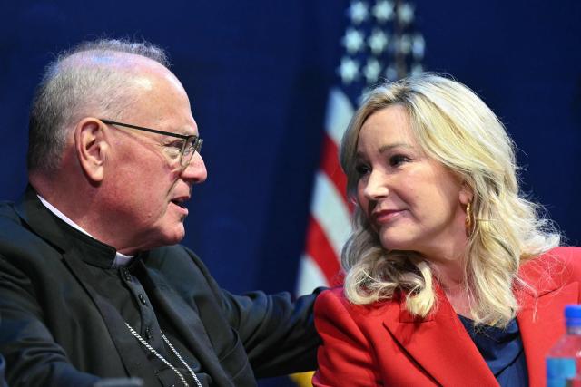 (FILES) Archbishop of New York Cardinal Timothy Dolan speaks with Senior Advisor to the White House Faith Office Paula White before US President Donald Trump speaks during a meeting on religious liberty in education at the Museum of the Bible in Washington, DC, on September 8, 2025. Pope Leo XIV has accepted the resignation of influential New York Archbishop Timothy Dolan, a leading figure of the US church's conservative wing, the Vatican said on December 18, 2025. (Photo by SAUL LOEB / AFP)