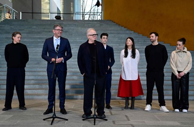 German State Minister for Culture and Media Wolfram Weimer (2nd L) and German musician Herbert Groenemeyer (3rd L) give a press statement as in background can be seen German musicians Maeckes (L), and (R-L) Karo Schrader, Daniel Grunenberg, Balbina and Christopher Annen following a meeting in which they discussed the effects of music streaming at the Chancellery in Berlin on December 18, 2025. (Photo by John MACDOUGALL / AFP)