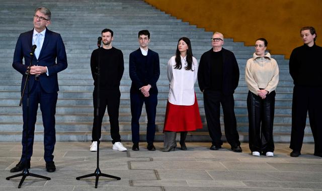 German State Minister for Culture and Media Wolfram Weimer (L) and German musicians (2nd L-R) Daniel Grunenberg, Christopher Annen, Balbina, Herbert Groenemeyer, Karo Schrader and Maeckes give a press statement following a meeting in which they discussed the effects of music streaming at the Chancellery in Berlin on December 18, 2025. (Photo by John MACDOUGALL / AFP)