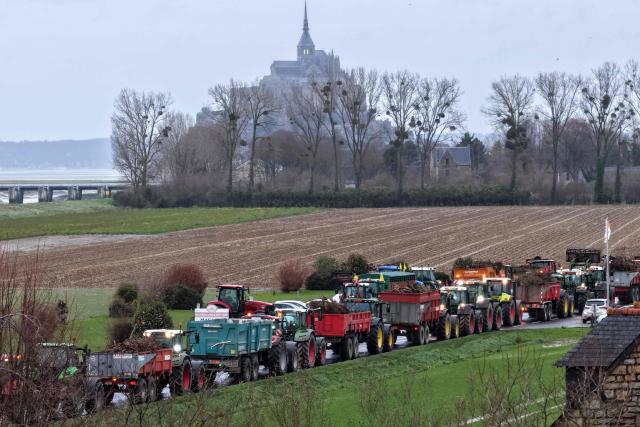 This aerial view shows tractors during a demonstration organised by Coordination Rurale farmers union close to the Mont-Saint-Michel, northwestern France on December 18, 2025. The main farming unions will be received on December 19, 2025 by French Prime Minister, who oversaw the latest announcements on managing the lumpy skin disease (LSD) "dermatose nodulaire contagieuse" outbreak, which sparked the resurgence of farmers’ anger fueled by the EU-Mercosur agreement. (Photo by Damien MEYER / AFP)