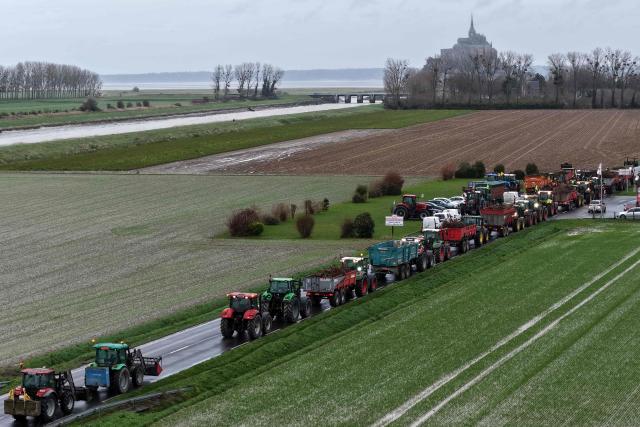 This aerial view shows tractors during a demonstration organised by Coordination Rurale farmers union close to the Mont-Saint-Michel, northwestern France on December 18, 2025. The main farming unions will be received on December 19, 2025 by French Prime Minister, who oversaw the latest announcements on managing the lumpy skin disease (LSD) "dermatose nodulaire contagieuse" outbreak, which sparked the resurgence of farmers’ anger fueled by the EU-Mercosur agreement. (Photo by Damien MEYER / AFP)