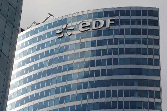 (FILES) Picture taken on September 14 2023, shows the  EDF building and logo in La Defense area, near Paris. The energy giant EDF has sharply revised upward the projected cost of the program for six EPR2 nuclear reactors, now estimated at Ђ72.8 billion, an increase of around 40% compared with the initial estimate on December 18, 2025. (Photo by Ludovic MARIN / AFP)