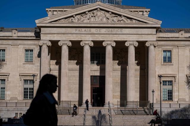 This photograph taken on December 18, 2025 shows people passing by the "Palais de Justice" courthouse of Marseille, southern France. (Photo by MIGUEL MEDINA / AFP)