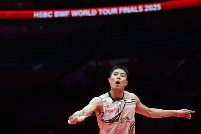 Taiwan’s Chou Tien-chen hits a return to China’s Shi Yuqi during their men’s singles match at the BWF Badminton World Tour Finals at the Hangzhou Olympic Sports Centre Gymnasium in Hangzhou, in eastern China's Zhejiang province on December 18, 2025. (Photo by Jade Gao / AFP)