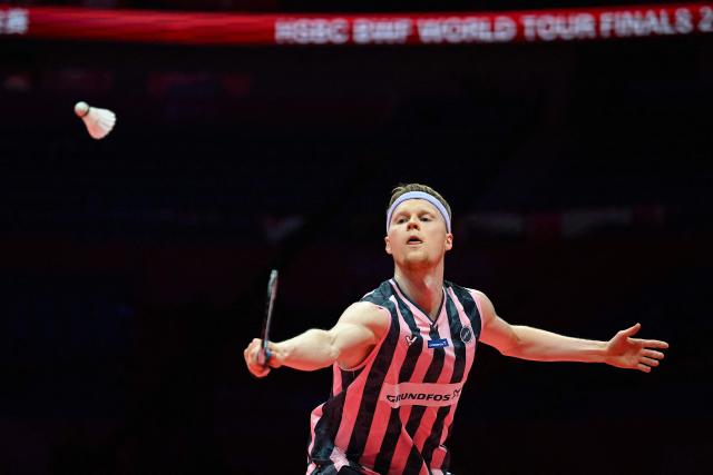 Denmark’s Anders Antonsen hits a return to Indonesia’s Jonatan Christie during their men's singles match at the BWF Badminton World Tour Finals at the Hangzhou Olympic Sports Centre Gymnasium in Hangzhou, in eastern China's Zhejiang province on December 18, 2025. (Photo by Jade Gao / AFP)