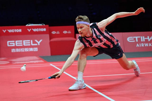 Denmark’s Anders Antonsen hits a return to Indonesia’s Jonatan Christie during their men's singles match at the BWF Badminton World Tour Finals at the Hangzhou Olympic Sports Centre Gymnasium in Hangzhou, in eastern China's Zhejiang province on December 18, 2025. (Photo by Jade Gao / AFP)