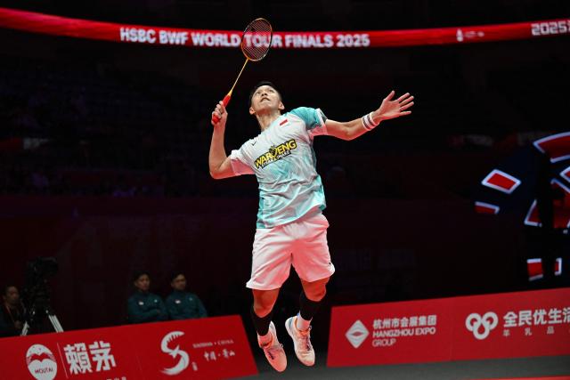 Indonesia’s Jonatan Christie hits a return to Denmark’s Anders Antonsen during their men's singles match at the BWF Badminton World Tour Finals at the Hangzhou Olympic Sports Centre Gymnasium in Hangzhou, in eastern China's Zhejiang province on December 18, 2025. (Photo by Jade Gao / AFP)