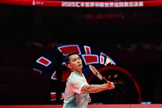 Indonesia’s Jonatan Christie hits a return to Denmark’s Anders Antonsen during their men's singles match at the BWF Badminton World Tour Finals at the Hangzhou Olympic Sports Centre Gymnasium in Hangzhou, in eastern China's Zhejiang province on December 18, 2025. (Photo by Jade Gao / AFP)