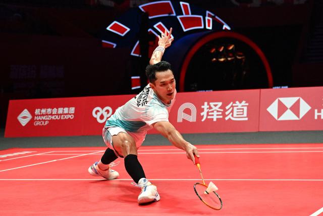 Indonesia’s Jonatan Christie hits a return to Denmark’s Anders Antonsen during their men's singles match at the BWF Badminton World Tour Finals at the Hangzhou Olympic Sports Centre Gymnasium in Hangzhou, in eastern China's Zhejiang province on December 18, 2025. (Photo by Jade Gao / AFP)