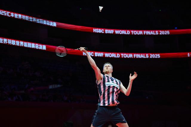 Denmark’s Anders Antonsen hits a return to Indonesia’s Jonatan Christie during their men's singles match at the BWF Badminton World Tour Finals at the Hangzhou Olympic Sports Centre Gymnasium in Hangzhou, in eastern China's Zhejiang province on December 18, 2025. (Photo by Jade Gao / AFP)