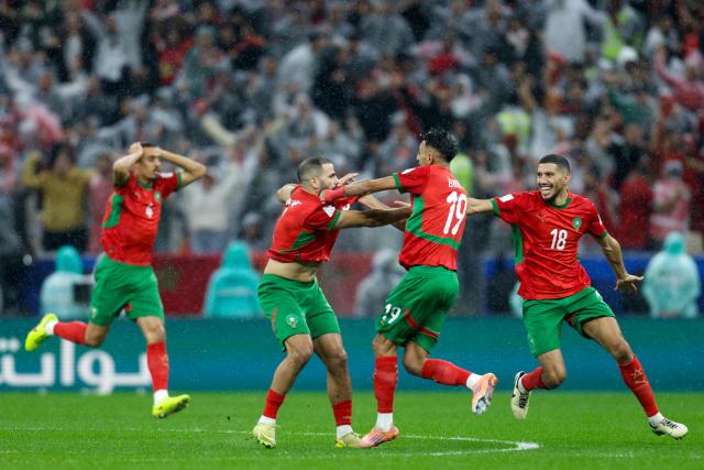 Morocco's players celebrate their team's first goal during the FIFA Arab Cup 2025 final football match between Jordan and Morocco at the Lusail Stadium Stadium, in Lusail on December 18, 2025. (Photo by Karim JAAFAR / AFP)