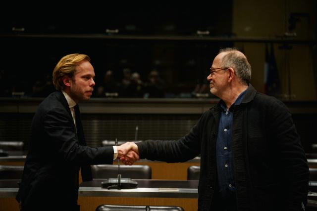 French journalist Thomas Legrand (R) shakes hands with French right wing party Union Des Droites' MP and rapporteur of the National Assembly commission on the neutrality, operation, and funding of public broadcasting Charles Alloncle prior to the start of a hearing before the Public Audiovisual Committee of Inquiry at the National Assembly building, France's Parliament lower house, in Paris on December 18, 2025. (Photo by Dimitar DILKOFF / AFP)