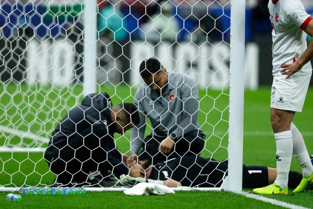 Team medics tend to Jordan's goalkeeper #1 Yazeed Abulaila during the FIFA Arab Cup 2025 final football match between Jordan and Morocco at the Lusail Stadium  Stadium, in Lusail on December 18, 2025. (Photo by Karim JAAFAR / AFP)