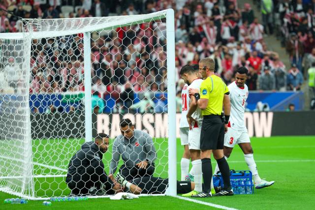 Team medics tend to Jordan's goalkeeper #1 Yazeed Abulaila during the FIFA Arab Cup 2025 final football match between Jordan and Morocco at the Lusail Stadium  Stadium, in Lusail on December 18, 2025. (Photo by Karim JAAFAR / AFP)