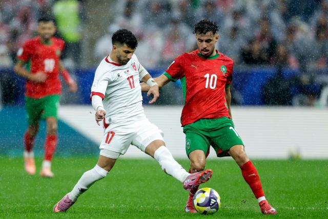 Jordan's midfielder #17 Issam Smeeri vies for the ball with Morocco's forward #10 Amin Zahzouh during the FIFA Arab Cup 2025 final football match between Jordan and Morocco at the Lusail Stadium  Stadium, in Lusail on December 18, 2025. (Photo by Karim JAAFAR / AFP)