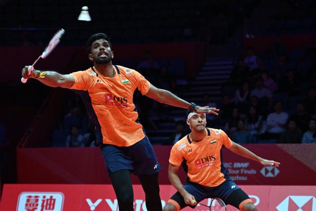 India’s Satwiksairaj Rankireddy and Chirag Shetty play a point during their men's doubles match against Indonesia’s Fajar Alfian and Muhammad Shohibul Fikri at the BWF Badminton World Tour Finals at the Hangzhou Olympic Sports Centre Gymnasium in Hangzhou, in eastern China's Zhejiang province on December 18, 2025. (Photo by Jade Gao / AFP)