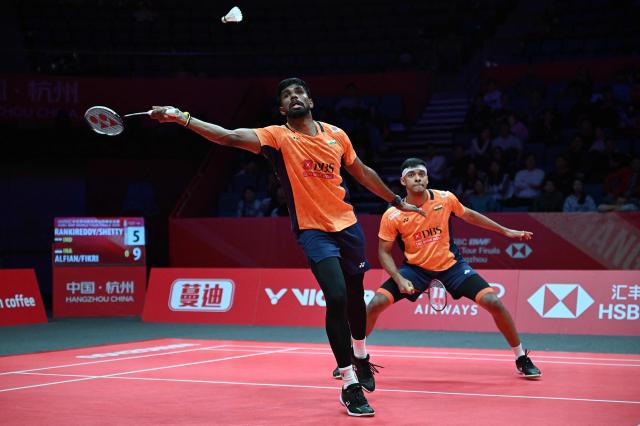 India’s Satwiksairaj Rankireddy and Chirag Shetty play a point during their men's doubles match against Indonesia’s Fajar Alfian and Muhammad Shohibul Fikri at the BWF Badminton World Tour Finals at the Hangzhou Olympic Sports Centre Gymnasium in Hangzhou, in eastern China's Zhejiang province on December 18, 2025. (Photo by Jade Gao / AFP)