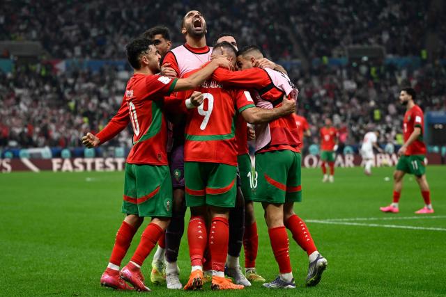 Morocco's forward #9 Abderrazzaq Hamed Allah celebrates with his teammates after scoring his team's seccond goal during the FIFA Arab Cup 2025 final football match between Jordan and Morocco at the Lusail Stadium  Stadium, in Lusail on December 18, 2025. (Photo by Mahmud HAMS / AFP)