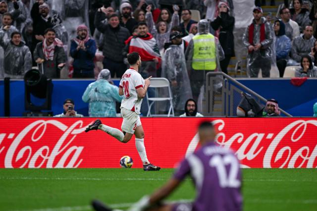 Jordan's midfielder #20 Mohannad Abutaha celebrates a goal that was later disallowed during the FIFA Arab Cup 2025 final football match between Jordan and Morocco at the Lusail Stadium  Stadium, in Lusail on December 18, 2025. (Photo by Mahmud HAMS / AFP)