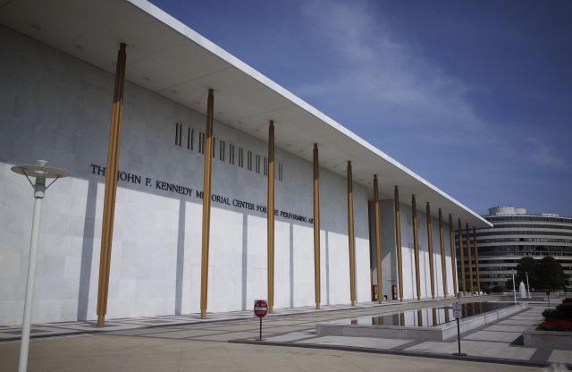 (FILES) Pedestrians walk up a sidewalk to the John F. Kennedy Center for the Performing Arts on August 16, 2014 in Washington, DC. The US capital's renowned John F. Kennedy arts center is to be renamed the "Trump-Kennedy Center" after President Donald Trump, the White House announced on December 18, 2025. Press Secretary Karoline Leavitt said the center's board -- which Trump purged of Democrats earlier this year -- voted for the change because of the Republican's "unbelievable work" in overhauling the famed venue. (Photo by Mandel NGAN / AFP)