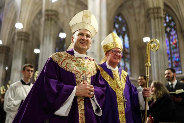 Cardinal Timothy Dolan (R) and his successor Ronald Hicks arrive to lead a mass at St. Patrick's Cathedral in the Manhattan borough of New York City on December 18, 2025. Pope Leo XIV has accepted the resignation of New York's conservative Archbishop Timothy Dolan and named a little-known, pro-migrant bishop from his native Chicago to replace him, the Vatican said on December 18. (Photo by CHARLY TRIBALLEAU / AFP)