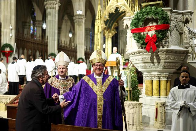 Cardinal Timothy Dolan (R) and his successor Ronald Hicks arrive to lead a mass at St. Patrick's Cathedral in the Manhattan borough of New York City on December 18, 2025. Pope Leo XIV has accepted the resignation of New York's conservative Archbishop Timothy Dolan and named a little-known, pro-migrant bishop from his native Chicago to replace him, the Vatican said on December 18. (Photo by CHARLY TRIBALLEAU / AFP)