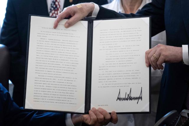 US President Donald Trump and Howard Kessler, founder of the Commonwealth Project, hold up an executive order easing restrictions on marijuana in the Oval Office at the White House in Washington, DC, on December 18, 2025. Trump said he was signing an executive order reclassifying marijuana as a less dangerous drug, in one of America's biggest shifts in drug policy for years. The move stops short of full federal legalization for recreational use across the United States but is aimed at encouraging medical research on the use of cannabis products. (Photo by Brendan Smialowski / AFP)