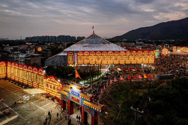 An aerial view shows the large bamboo ceremonial structure for staging rituals and performances during the decennial Jiao Festival of Kam Tin in Hong Kong on December 18, 2025. The Taoist ritual, held once every ten years, is performed to give thanks to deities, ward off misfortune and pray for peace and prosperity in the community. (Photo by Leung Man Hei / AFP)