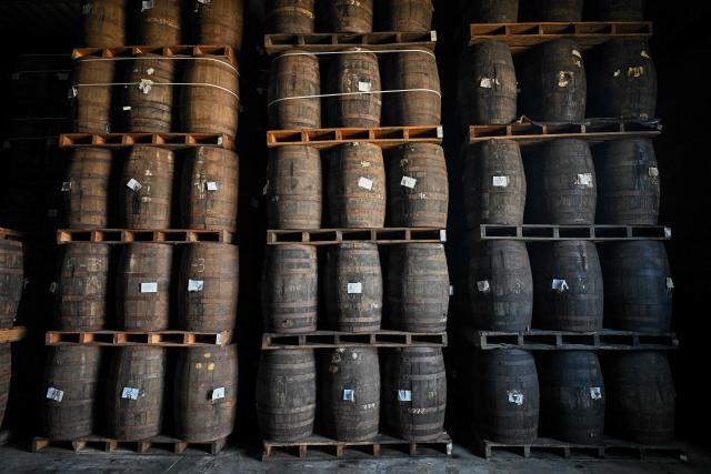 View of rum barrels stored in an aging warehouse at the Santa Teresa rum factory in La Victoria, Aragua state, Venezuela, on December 17, 2025. (Photo by Federico PARRA / AFP)