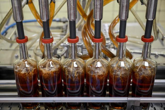 View of the bottle-filling line at the Santa Teresa rum factory in La Victoria, Aragua state, Venezuela, on December 17, 2025. (Photo by Federico PARRA / AFP)