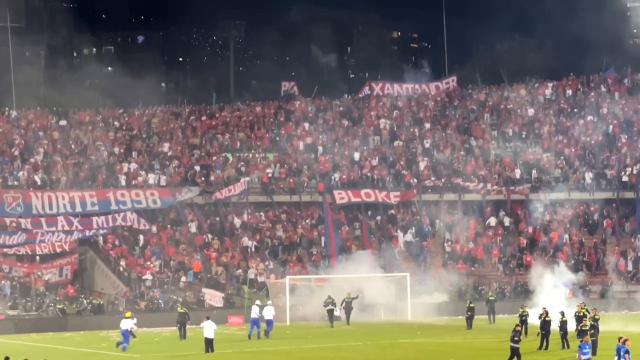 This AFPTV video grab shows clashes between fans during the Colombia's cup final football match between Deportivo Independiente Medellin and Atletico Nacional at the Atanasio Girardot stadium in Medellin, Colombia on December 17, 2025. At least 59 people were injured in clashes between football fans during Colombia's cup final in Medellin on the night of December 17, 2025, local authorities said. The unrest broke out at the end of the match which saw Atletico Nacional beat fellow Medellin side, Deportivo Independiente Medellin, 1-0. (Photo by AFPTV teams / AFPTV / AFP)