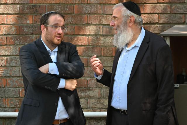Mourners talk as they arrive for the funeral of Boris and Sofia Gurman, who were killed in the December 14 Bondi Beach shooting attack, at the Sydney Chevra Kadisha in Sydney on December 19, 2025. Father-and-son gunmen are accused of firing into crowds at a beachside Jewish festival on December 14, killing 15 in an attack authorities linked to "Islamic State ideology". (Photo by Saeed KHAN / AFP)