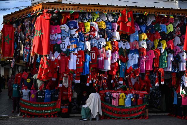 National football teams Jersey are displayed in a shop on a street market in Rabat, during the FIFA Arab Cup 2025 final football match between Jordan and Morocco on December 18, 2025. (Photo by Gabriel BOUYS / AFP)