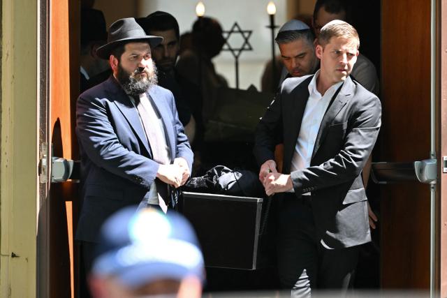 Pallbearers carry a coffin after the funeral of Boris and Sofia Gurman, who were killed in the December 14 Bondi Beach shooting attack, at the Sydney Chevra Kadisha in Sydney on December 19, 2025. Father-and-son gunmen are accused of firing into crowds at a beachside Jewish festival on December 14, killing 15 in an attack authorities linked to "Islamic State ideology". (Photo by Saeed KHAN / AFP)