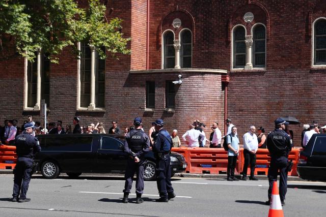 Police stand guard after the funeral of Boris and Sofia Gurman, who were killed in the December 14 Bondi Beach shooting attack, in Sydney on December 19, 2025. Father-and-son gunmen are accused of firing into crowds at a beachside Jewish festival on December 14, killing 15 in an attack authorities linked to "Islamic State ideology". (Photo by DAVID GRAY / AFP)