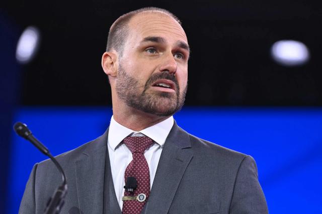 (FILES) Brazilian politician Eduardo Bolsonaro, son of Jair Bolsonaro, speaks during the annual Conservative Political Action Conference (CPAC) at the Gaylord National Resort & Convention Center at National Harbor in Oxon Hill, Maryland, on February 20, 2025. Brazil's Chamber of Deputies stripped Eduardo Bolsonaro, one of the sons of former president Jair Bolsonaro, of his seat in Parliament on December 18, 2025, due to his repeated absences from the chamber. Eduardo Bolsonaro, the third son of the ex-leader, has not attended the legislative headquarters in Brasilia since February, when he moved to the United States to lobby authorities there on behalf of his father, who is currently imprisoned for attempting a coup. (Photo by SAUL LOEB / AFP)
