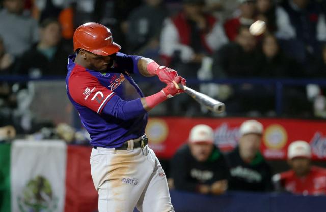 (FILES) Dominican Republic's Leones del Escogido fielder Junior Lake hits the ball in the eighth inning of the Caribbean Series baseball tournament first place play-off game between Dominican Republic and Mexico at Estadio El Nido De Los Aguilas in Mexicali, Baja California state, Mexico on February 7, 2025. Mexico will be the new host of the 2026 Caribbean Series baseball tournament after some teams declined to travel to Venezuela, the initial host, amid the crisis over the United States military deployment in the Caribbean, organizers announced on December 18, 2025. (Photo by FAUSTO IBARRA / AFP)