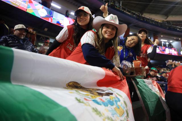 (FILES) Mexico's fans pose for a picture before the Caribbean Series baseball tournament first place play-off game between Dominican Republic and Mexico at Estadio El Nido De Los Aguilas in Mexicali, Baja California state, Mexico on February 7, 2025. Mexico will be the new host of the 2026 Caribbean Series baseball tournament after some teams declined to travel to Venezuela, the initial host, amid the crisis over the United States military deployment in the Caribbean, organizers announced on December 18, 2025. (Photo by FAUSTO IBARRA / AFP)