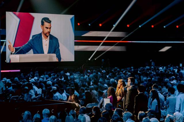 Attendees listen to US conservative political commentator Ben Shapiro speaks during Turning Point's annual AmericaFest conference in remembrance of late right-wing political activist Charlie Kirk, in Phoenix, Arizona on December 18, 2025. (Photo by Olivier Touron / AFP)