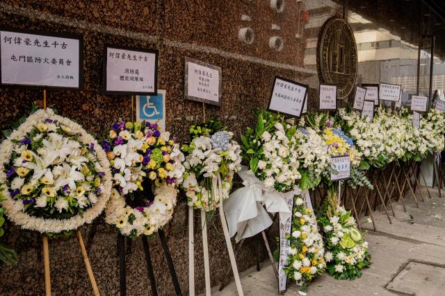 Floral tributes placed in mourning at the funeral for firefighter Ho Wai-ho, who died in the deadly fire at the Wang Fuk Court residential estate in Tai Po district, at the Universal Funeral Parlour in Hung Hom, Hong Kong, on December 19, 2025. (Photo by Leung Man Hei / AFP)