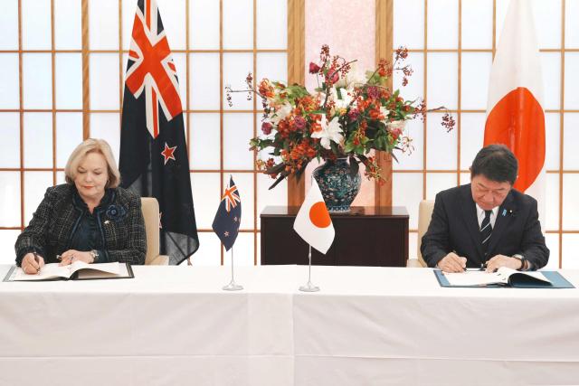 Japan's Foreign Minister Toshimitsu Motegi (R) and New Zealand's Defence Minister Judith Collins attend the signing of the Japan-New Zealand Acquisition and Cross-Servicing Agreement and the Japan-New Zealand Information Security Agreement, at the Foreign Ministry in Tokyo on December 19, 2025. (Photo by Kazuhiro NOGI / AFP)
