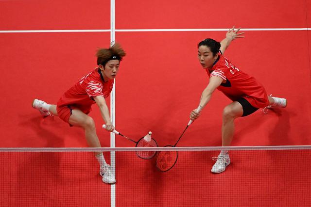 China’s Jia Yifan (R) and Zhang Shuxian play a point during their women's doubles match against Japan’s Rin Iwanaga and Kie Nakanishi at the BWF Badminton World Tour Finals at the Hangzhou Olympic Sports Centre Gymnasium in Hangzhou, in eastern China's Zhejiang province on December 19, 2025. (Photo by Jade Gao / AFP)