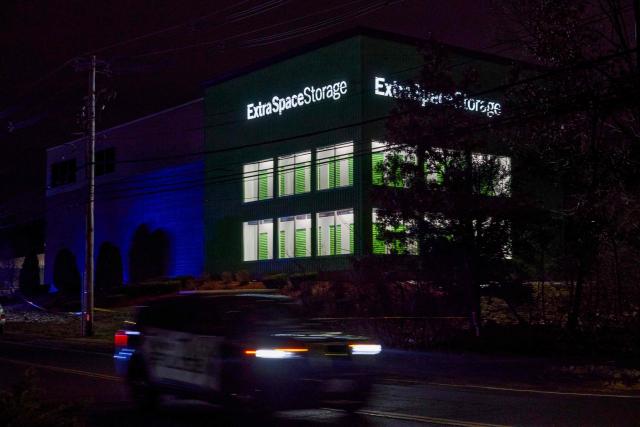 A Salem Police Department cruiser drives past the storage facility where the suspect behind the mass shooting at Brown University was found dead, in Salem, New Hampshire, on December 19, 2025. A man believed to be behind both a mass shooting at Brown University and the killing of an MIT professor has been found dead after a days-long manhunt, authorities said Thursday. The suspect, Claudio Neves Valente, was a 48-year-old Portuguese national who had once studied physics at Brown, officials announced at press conferences in Providence and Boston. (Photo by Bing Guan / AFP)