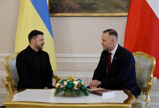 Poland's President Karol Nawrocki (R) and Ukraine's President Volodymyr Zelensky have taken seat for talks at the Presidential Palace in Warsaw, Poland, on December 19, 2025. (Photo by Wojtek RADWANSKI / AFP)