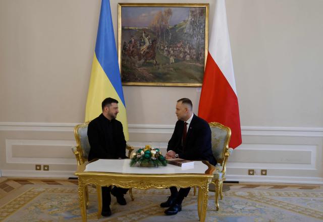 Poland's President Karol Nawrocki (R) and Ukraine's President Volodymyr Zelensky have taken seat for talks at the Presidential Palace in Warsaw, Poland, on December 19, 2025. (Photo by Wojtek RADWANSKI / AFP)
