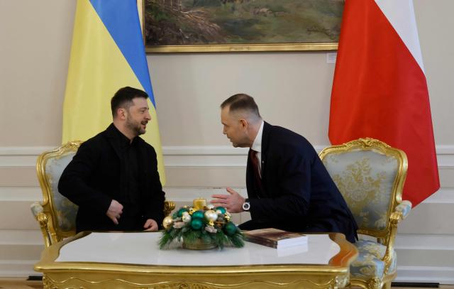 Poland's President Karol Nawrocki (R) and Ukraine's President Volodymyr Zelensky have taken seat for talks at the Presidential Palace in Warsaw, Poland, on December 19, 2025. (Photo by Wojtek RADWANSKI / AFP)
