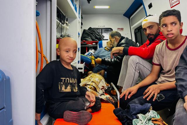(FILES) Medics evacuate injured people and cancer patients from the Kamal Adwan Hospital in Beit Lahia in the northern Gaza Strip on October 28, 2024, to al-Shifa hospital in Gaza City in a joint World Health Organisation and Palestinian Red Crescent initiative. More than 1,000 patients have died while waiting for urgent medical evacuation from war-ravaged Gaza in the last year and a half, the World Health Organization said on December 19, 2025. The WHO chief said on X that "1,092 patients have died while awaiting medical evacuation between July 2024 and November 28, 2025", warning that "this figure is likely underreported". (Photo by AFP)