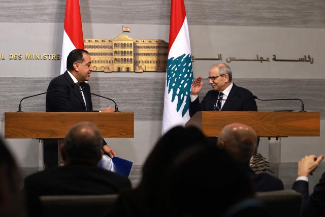 Lebanese Prime Minister Nawaf Salam (R) gestures during a joint press conference with his Egyptian counterpart Prime Minister Mostafa Madbouly (L) after their meeting in Beirut on December 19, 2025. (Photo by IBRAHIM AMRO / AFP)