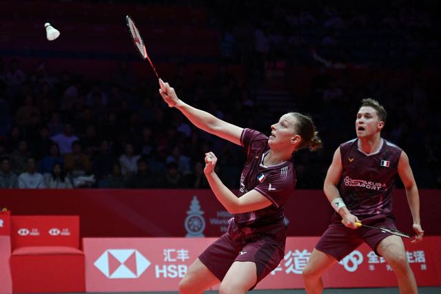 France’s Thom Gicquel and Delphine Delrue (L) play a point during their mixed doubles match against Japan’s Hiroki Midorikawa and Natsu Saito at the BWF Badminton World Tour Finals at the Hangzhou Olympic Sports Centre Gymnasium in Hangzhou, in eastern China's Zhejiang province on December 19, 2025. (Photo by Jade Gao / AFP)